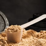 scoop-of-whey-protein-on-black-background-chocolate-royalty-free-image-619091536-1539637937