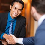 Two Smiling Business Partners Shaking Hands