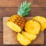 fresh-pineapple-sliced-on-chopping-board