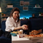 portrait-smiling-woman-looking-into-camera-sitting-couch-enjoying-free-time