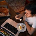 top-view-man-with-snack-laptop
