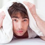 landscape-1490611482-sad-man-in-bed