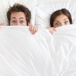 couple-sleeping-bed