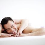 Couple laying in bed, arms around eachother